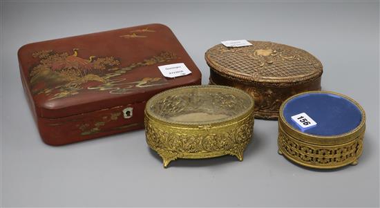 A Japanese red lacquered box, an oval gilt composition box and cover and two gilt boxes largest 18.5 x 24cm